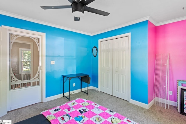 bedroom featuring carpet, a closet, crown molding, and baseboards
