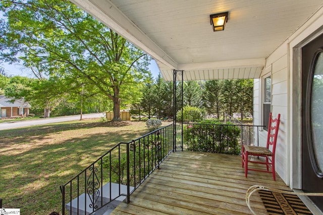 deck with a porch and a yard