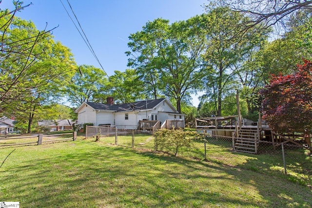 view of yard featuring a wooden deck and a fenced backyard