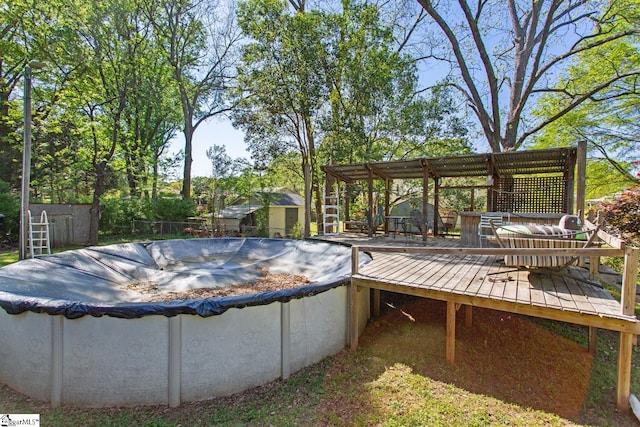 view of pool featuring a covered pool and a deck