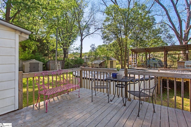 deck with an outbuilding and a storage shed