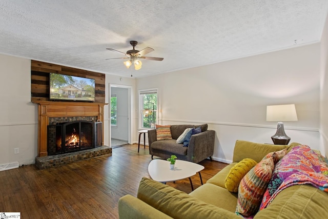 living area featuring a ceiling fan, wood finished floors, and a textured ceiling