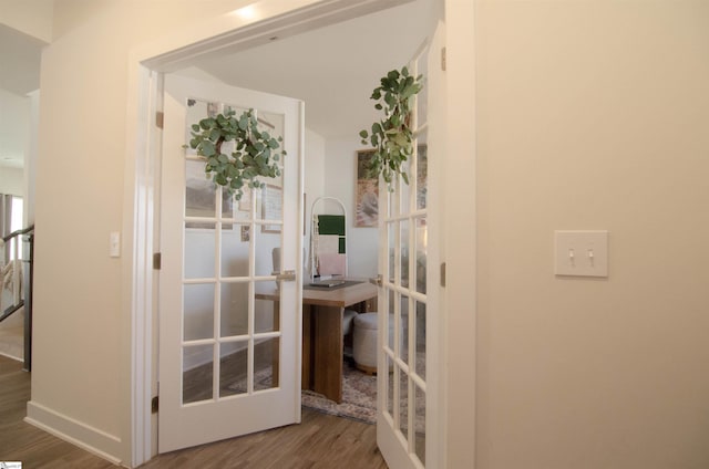 doorway with baseboards, french doors, and wood finished floors