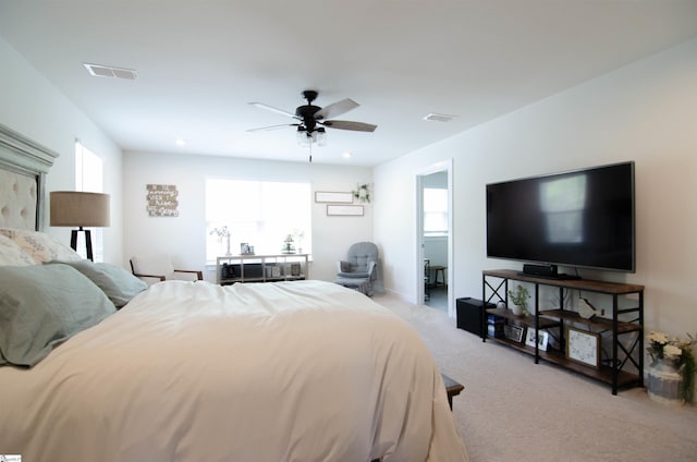 carpeted bedroom with visible vents, ceiling fan, and multiple windows