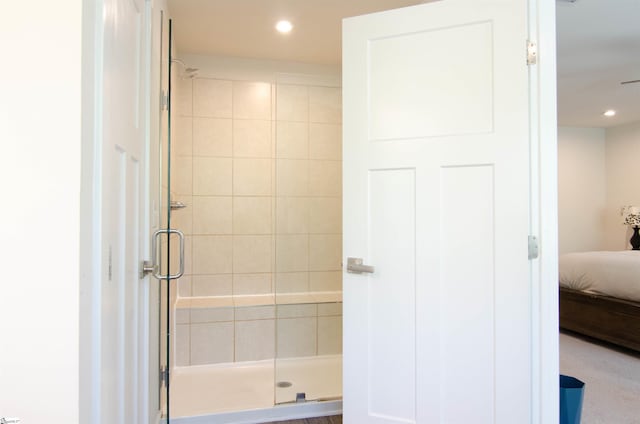 ensuite bathroom featuring connected bathroom, recessed lighting, and a stall shower