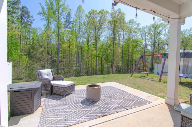 view of patio featuring a trampoline and a playground