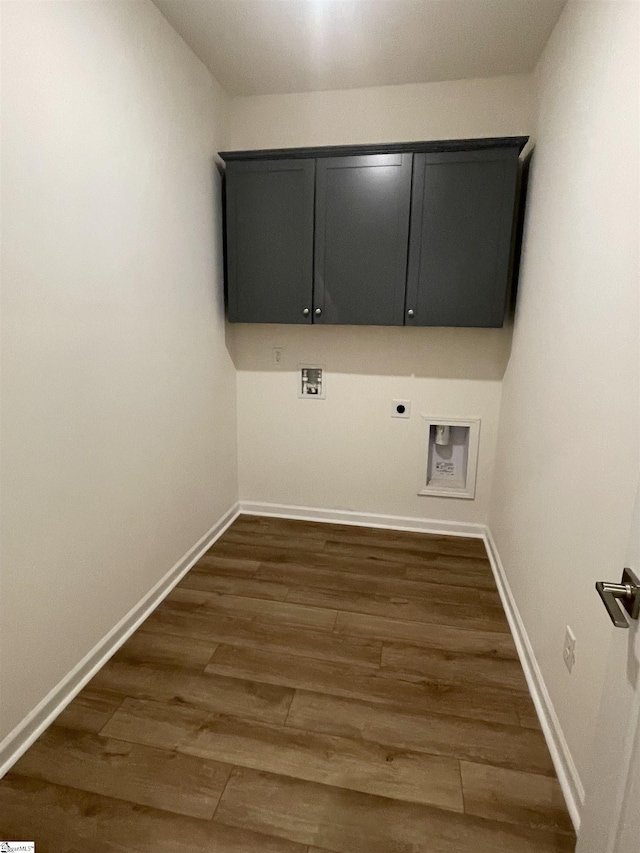 clothes washing area with hookup for a washing machine, hookup for an electric dryer, cabinet space, baseboards, and dark wood-type flooring