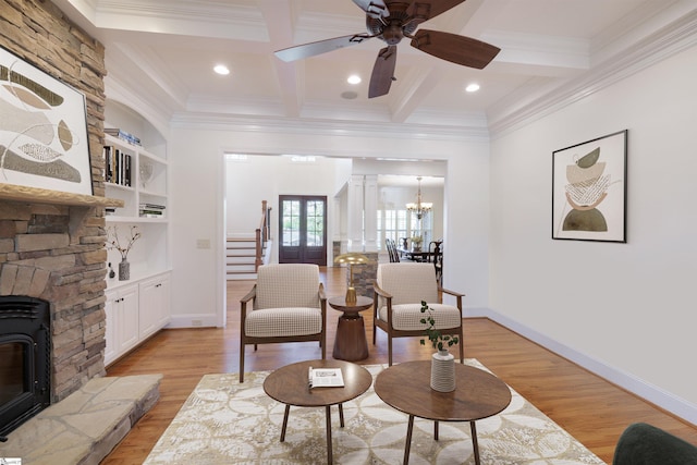 living area with light wood-type flooring, coffered ceiling, and ornamental molding