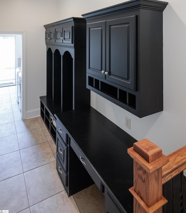 mudroom featuring baseboards and light tile patterned flooring