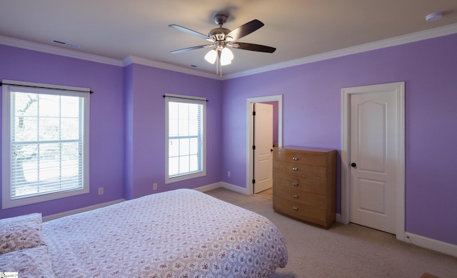 bedroom featuring ornamental molding, baseboards, multiple windows, and light colored carpet