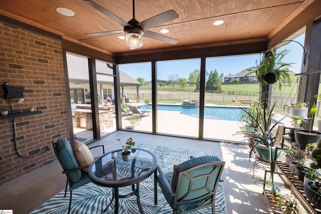 sunroom featuring wooden ceiling, ornamental molding, outdoor dining area, and a ceiling fan