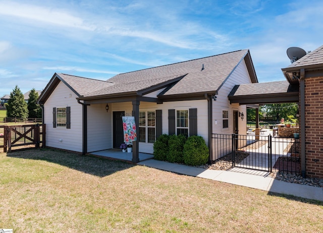 view of front of property featuring a gate, fence, a patio, and a front yard