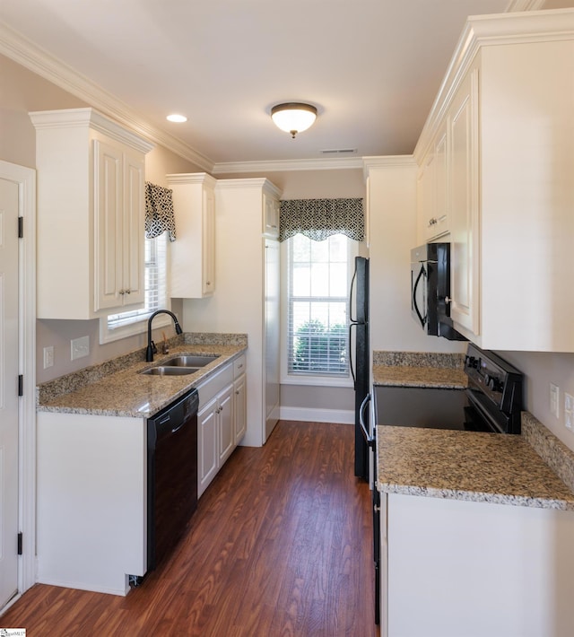 kitchen with white cabinets, a sink, black appliances, dark wood-type flooring, and ornamental molding