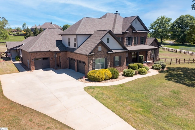 view of front of house featuring fence, a front lawn, concrete driveway, brick siding, and a garage