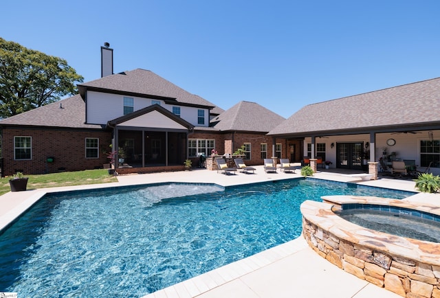 view of pool featuring a ceiling fan, french doors, a patio, a sunroom, and a pool with connected hot tub