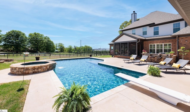 view of swimming pool featuring a fenced in pool, a sunroom, a fenced backyard, and a patio
