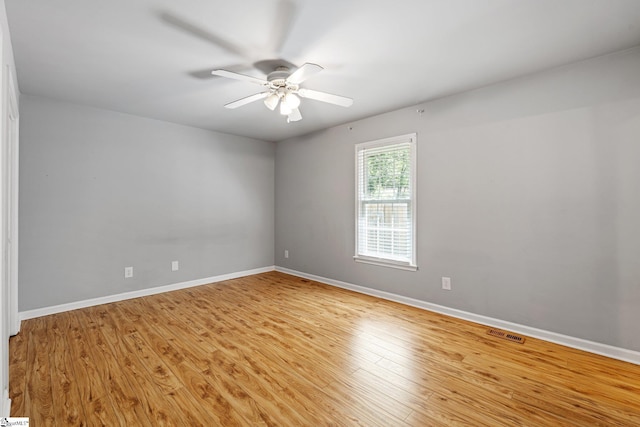 unfurnished room with light wood-style flooring, visible vents, baseboards, and ceiling fan