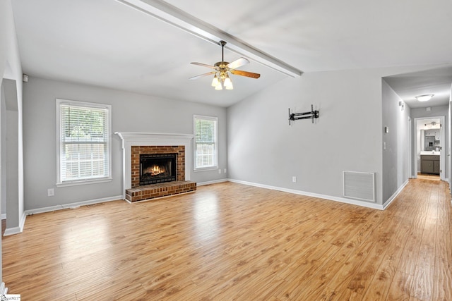 unfurnished living room featuring light wood-type flooring, plenty of natural light, and visible vents