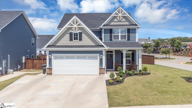 2 Yakama Way, Greenville, SC 29607 - craftsman house featuring concrete driveway, covered porch, fence, a front yard, and a garage