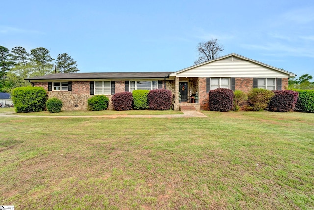 ranch-style home with brick siding and a front yard