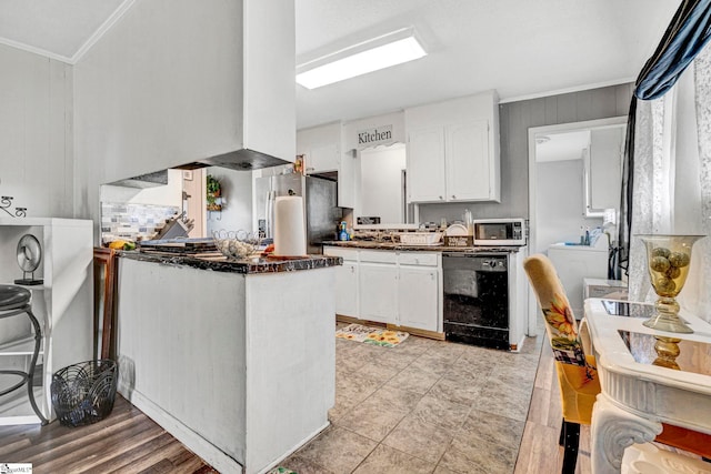 kitchen featuring dark countertops, appliances with stainless steel finishes, crown molding, and white cabinetry