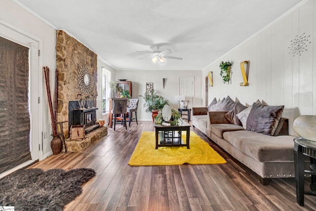 living area with hardwood / wood-style floors, ornamental molding, and ceiling fan
