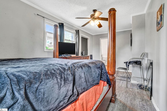 bedroom with wood finished floors, a textured ceiling, baseboards, and ornamental molding