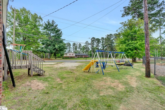 view of jungle gym featuring fence and a yard