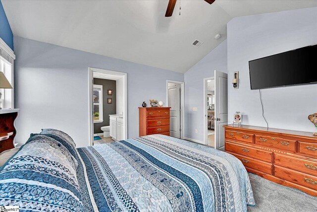 bedroom with light carpet, visible vents, lofted ceiling, ceiling fan, and ensuite bath