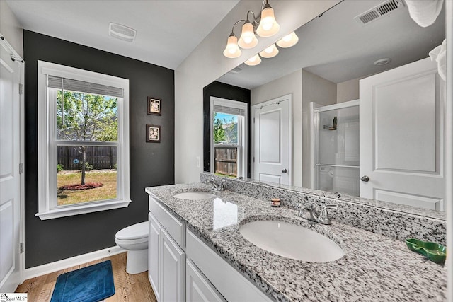 bathroom featuring a shower stall, visible vents, baseboards, and a sink