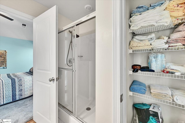 bathroom with visible vents and a stall shower