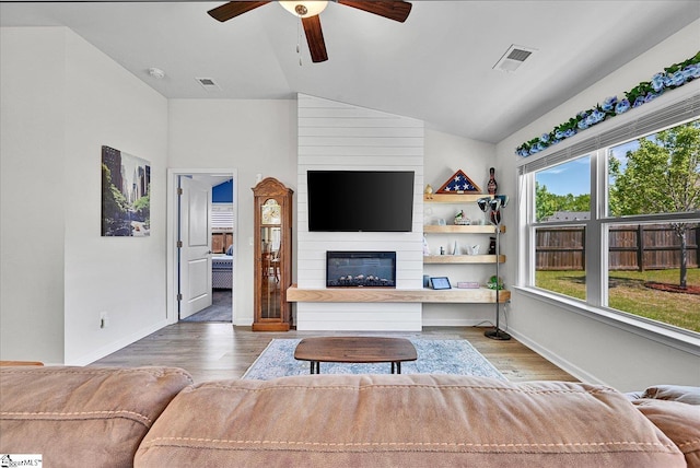 living room featuring visible vents, vaulted ceiling, wood finished floors, and ceiling fan