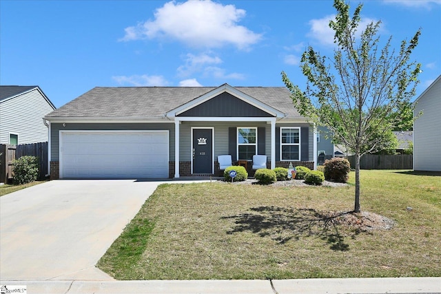 ranch-style house with a front lawn, driveway, fence, a garage, and brick siding
