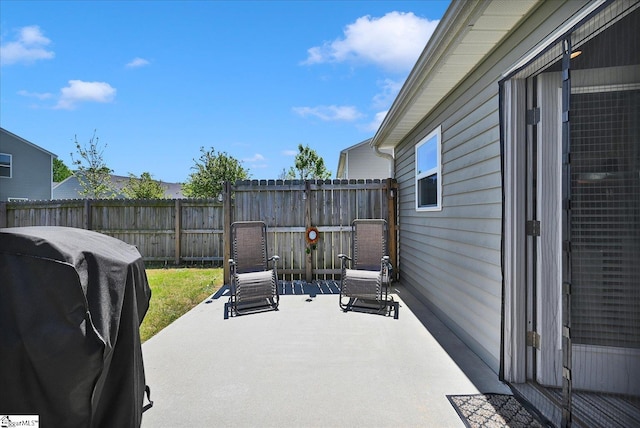 view of patio with grilling area and a fenced backyard