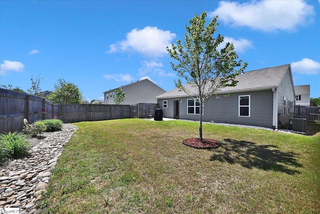 view of yard featuring a fenced backyard and central AC unit