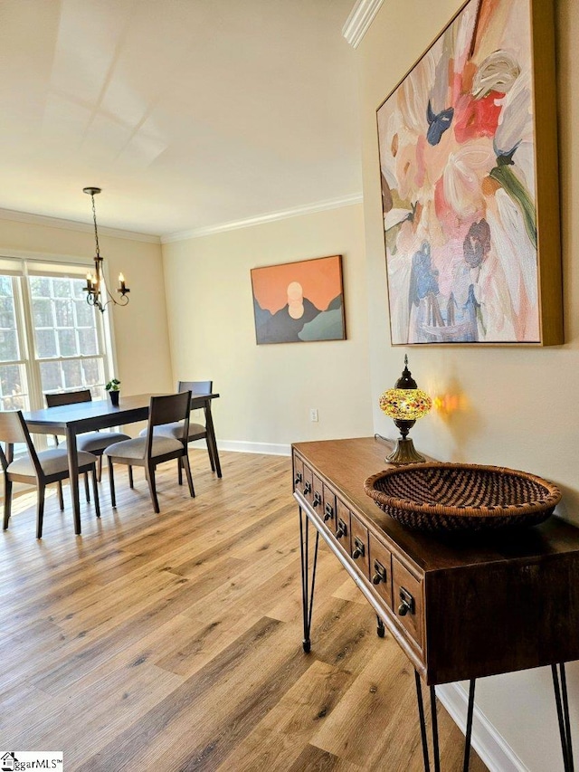949 Jones Mill Rd, Fountain Inn, SC 29644 - dining space with light wood-style flooring, crown molding, baseboards, and a notable chandelier