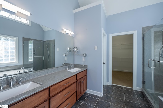 bathroom featuring a shower stall, tile patterned flooring, and a sink