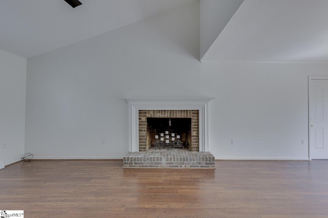 unfurnished living room with a fireplace, wood finished floors, and baseboards
