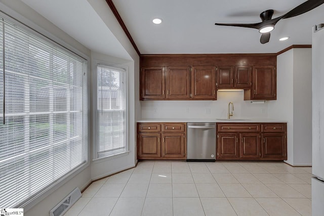 kitchen with light countertops, visible vents, a ceiling fan, stainless steel dishwasher, and a sink