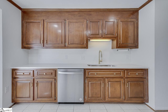 kitchen with dishwasher, light countertops, a sink, and brown cabinets