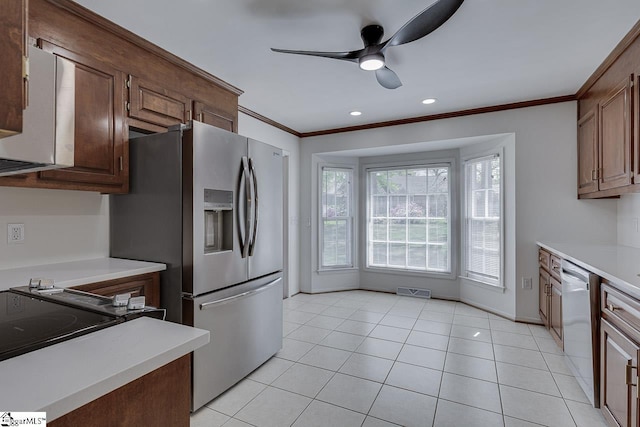 kitchen with light countertops, ornamental molding, appliances with stainless steel finishes, and a ceiling fan