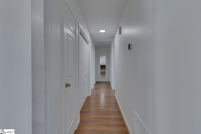 corridor with attic access, visible vents, recessed lighting, and dark wood-type flooring