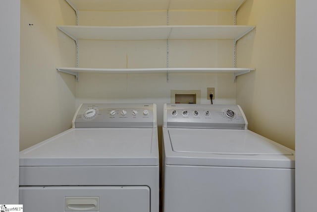 laundry room featuring washing machine and clothes dryer and laundry area