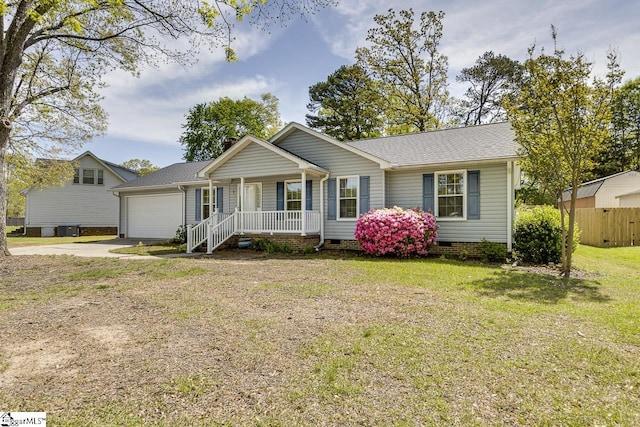 ranch-style home featuring a front lawn, driveway, a porch, an attached garage, and crawl space