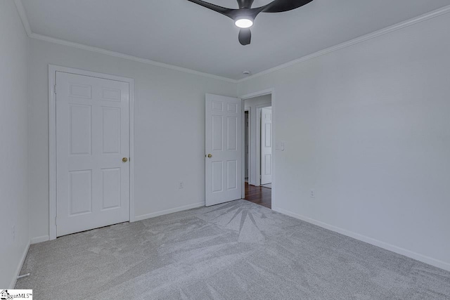 unfurnished bedroom with baseboards, carpet, and ornamental molding