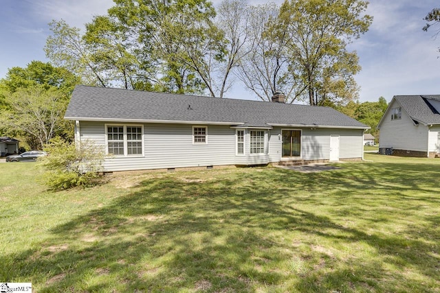 rear view of property with a lawn, crawl space, a chimney, and central AC