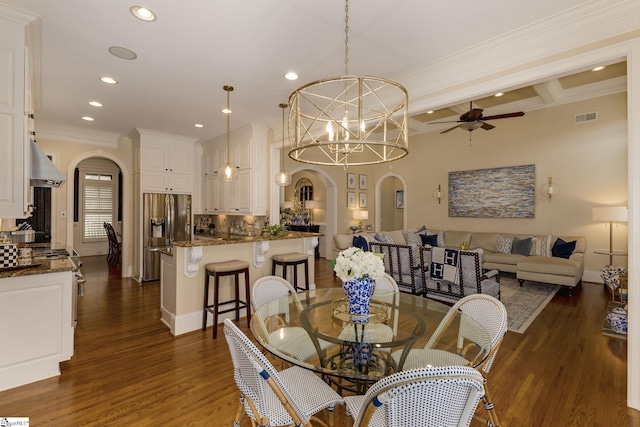 dining room with arched walkways, a ceiling fan, recessed lighting, dark wood-style flooring, and ornamental molding