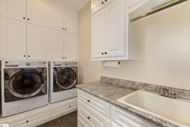 laundry area featuring washer and clothes dryer, cabinet space, crown molding, and dark tile patterned floors