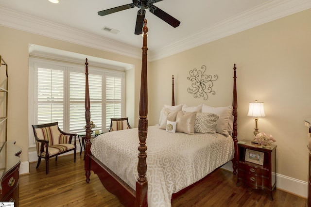 bedroom with baseboards, wood finished floors, crown molding, and ceiling fan