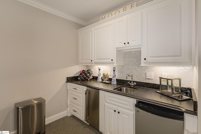 kitchen featuring a sink, dark countertops, refrigerator, white cabinetry, and ornamental molding